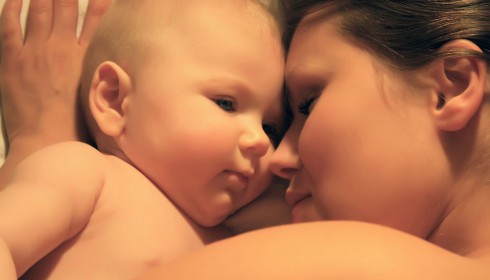 Eine Mutter kuschelt ihren Säugling